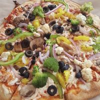 Custom pizza loaded with Daiya cheese and fresh veggies at Dells Pizza Lab in Wisconsin Dells