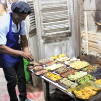 Owner arranging the food at Baracoando in Baracoa