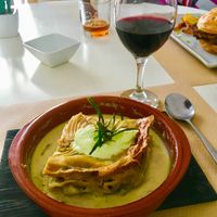Lasagna and a glass of house wine.  at Nomit in Valencia