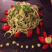 zucchini noodles with sun ripened datternino cherry tomatoes and a deliciously creamy avocado and almond pesto. at Albisbe4 in Alghero