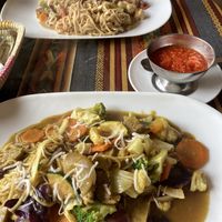 Coconut curry and peanut satay noodles with soy meat  at Cafe Good in Banos