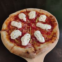 Pizza with vegan mozzarella on top at Trivoli Vegan Kafeneio in Athens