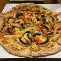 Tasty pizza with creamy cheese at Trivoli Vegan Kafeneio in Athens