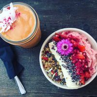 Tropical smoothie and pink bowl at Coco Bowls in Warsaw
