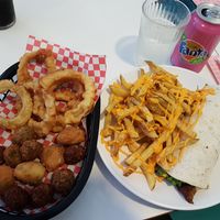 Vegetarian wrap, fries with nacho cheese, onion rings, jalapeño popers, veggie balls, falaffel balls, cream soda Fanta. at Jeni's Diner in Caminha