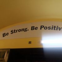 Inspirational quote over the exit at Loving Hut in Prague