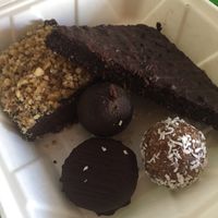 Clockwise from top left: Raw Fudge Bar, Dirty Brownie*, Vanilla Caramel Ball, Reese’s PB Cup, and Chocolate Matcha Ball. All vegan. at Green Table  in Santa Barbara