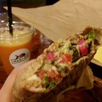 Orange juice and small flat bread with pineapple and avocado. at Mango Vegan Street Food - Zlota in Warsaw