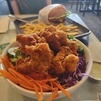 Vegan Joint Bowl with Fried Oyster Mushrooms and Black Bean Burger in the background  at TVJ Kitchen - West LA in Los Angeles