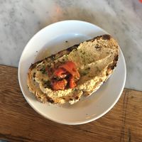 Vegan hummus toast with herbed oil and roasted red pepper. Small but tasty! at Kaffihus Vesturbæjar in Reykjavik