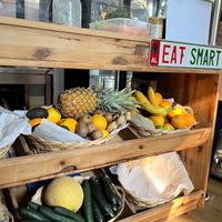 Gorgeous fresh produce under the counter and an Albanian license plate that says EAT SMART at Happy Belly / Eat Smart in Tirana