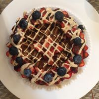 Waffles with strawberry, blueberry, vanilla cream, and coconut manjar  at Raw Cafe - La Molina in Lima