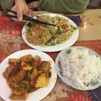 Country style tofu (tomato, pineapple, onion...) 40,000VND (small size) with rice 10,000VND in the front. In the back stir-fries noodles with vegetables 60,000VND (big size)  at Bao Anh in Ninh Binh