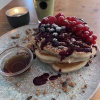 pancakes with berries, granola & maple syrup and matcha latte with almond milk  at Emmi's Kitchen - Glockenbach in Munich