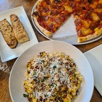 Vegan pepperoni pizza and mac & cheese pasta with garlic focaccia at Virtuous Pie  in Vancouver