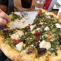 Ultraviolet pizza with walnut pesto, cashew mozzarella, tomato and caramelized onions   at Virtuous Pie  in Vancouver