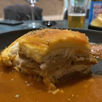 Cheese coated sandwich with in tomato soup (traditional Portuguese dish in vegan)  at 26 Vegan Food Project in Lisbon