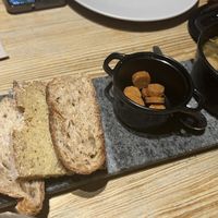 Convert plate with nice bread, soup of mushrooms   at 26 Vegan Food Project in Lisbon