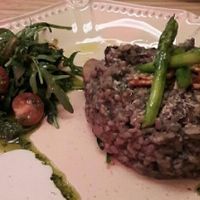 risotto and seitan steak in background at 26 Vegan Food Project in Lisbon