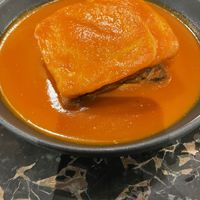 Portuguese speciality of bread and meat with a cheese and tomato sauce   at 26 Vegan Food Project in Lisbon