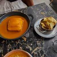 Francesinha and homemade potato chips at 26 Vegan Food Project in Lisbon