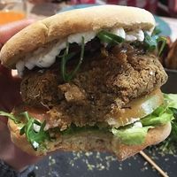Meaty Lentils:  Burger Lentils on toasted Bolo do aco bread with Garli and herbs butter, arugula, caramelized onions, tomato and homemade Mayonnaise  at 26 Vegan Food Project in Lisbon