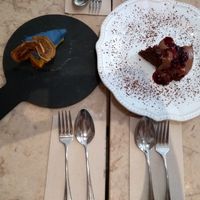 Delicious dessert. Orange cheesecake made with raw ingredients and chocolate cake with berry cover at 26 Vegan Food Project in Lisbon