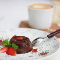 Capuccino with almond milk and tasty raw dessert  at Groot in Moscow