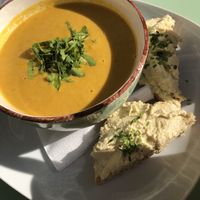 Carrot, coconut and cumin soup... with hummus and bread to dip. Yum! at Flowers Kitchen in Luxembourg City