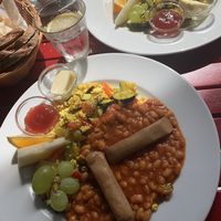 Tofu veggie scramble, beans, vegan sausage, spreads & bread basket  at Cafe V in Berlin