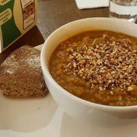 Vegan lentil soup and a piece of bread at SLA - Kerkplein in The Hague