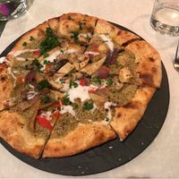 Pizza verde: green curry sauce, mushrooms, coconut cream at Mediamatic ETEN in Amsterdam