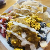 Breakfast bowl with beans, rice, tofu scramble, vegan cheese, pico & covered up in vegan green chili!🌶️   at The Corner Beet in Denver