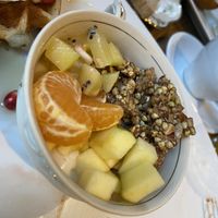 crème végétale rose-cardamome, fruits frais et granola de sarrasin germé.  at Les 4 Jeudis in Brussels