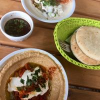 hummus with sun-dried tomatoes, hummus with fava beans, pita bread, garlic dip at Hummus & Friends in Berlin