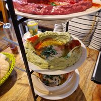 A stack of beetroot, avocado, and chickpea hummus at Hummus & Friends in Berlin