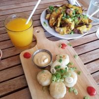 Orange juice, potatoes, yuca bites  at Holi Vegan Kitchen in North Miami Beach