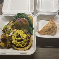Southwest Black Bean Burger with Loaded Potatoes; Impossible Empanada  at Holi Vegan Kitchen in North Miami Beach