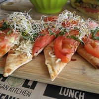 CAPRESE FLATBREAD PIZZETTA
mozzarella, tomato, basil  at Holi Vegan Kitchen in North Miami Beach