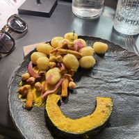 Gnocchi di patate con zucca cipolla nocciole   at Black Sheep Raw • Vegan Lab & Bistrot in Trento