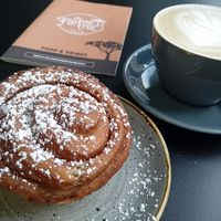 Decaf oat latte 4.85 and vg cinnamon bun 4.50 at The Flame Tree Cafe in Dundee