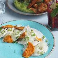 Vegan pierogi filled with tofu and mushrooms topped with sweet potatoes and vegan sour cream at Veganic in Krakow