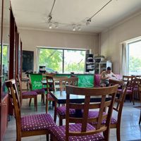 Seating with the food counter at the end   at Garda Pupa in Riga