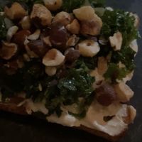 Bruschetta de creme de castanha, couve refogada e avelãs  at Casa Raw in Sao Paulo