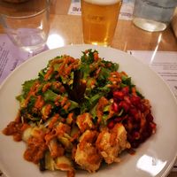Salad with vegan cheese, pomegranate and peanut sauce at El Fogon Verde in Madrid