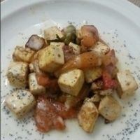 marinated tofu with lemon and pepper garnish at El Fogon Verde in Madrid