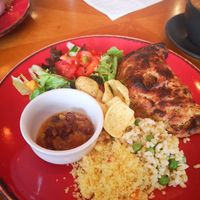 Picture of a red plate with a Guinness pasty, served with salad at Planetwise & Yoga Studio in Bridlington