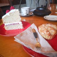 Picture of 2 cakes on red plates. Slice of Victoria sponge on the left, frangipane on the right at Planetwise & Yoga Studio in Bridlington