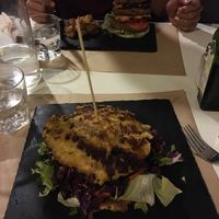 Delicious and huge platano/plantain burger! Monstruo/monster burger in the background at Cookaluzka in Madrid