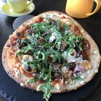 Vegan pizza with Mushrooms,Rocket,Red onion ,Chilli oil,Tomatoes ,Veggie haggis & Vegan cheese
  at Cafe Sia in Isle Of Skye